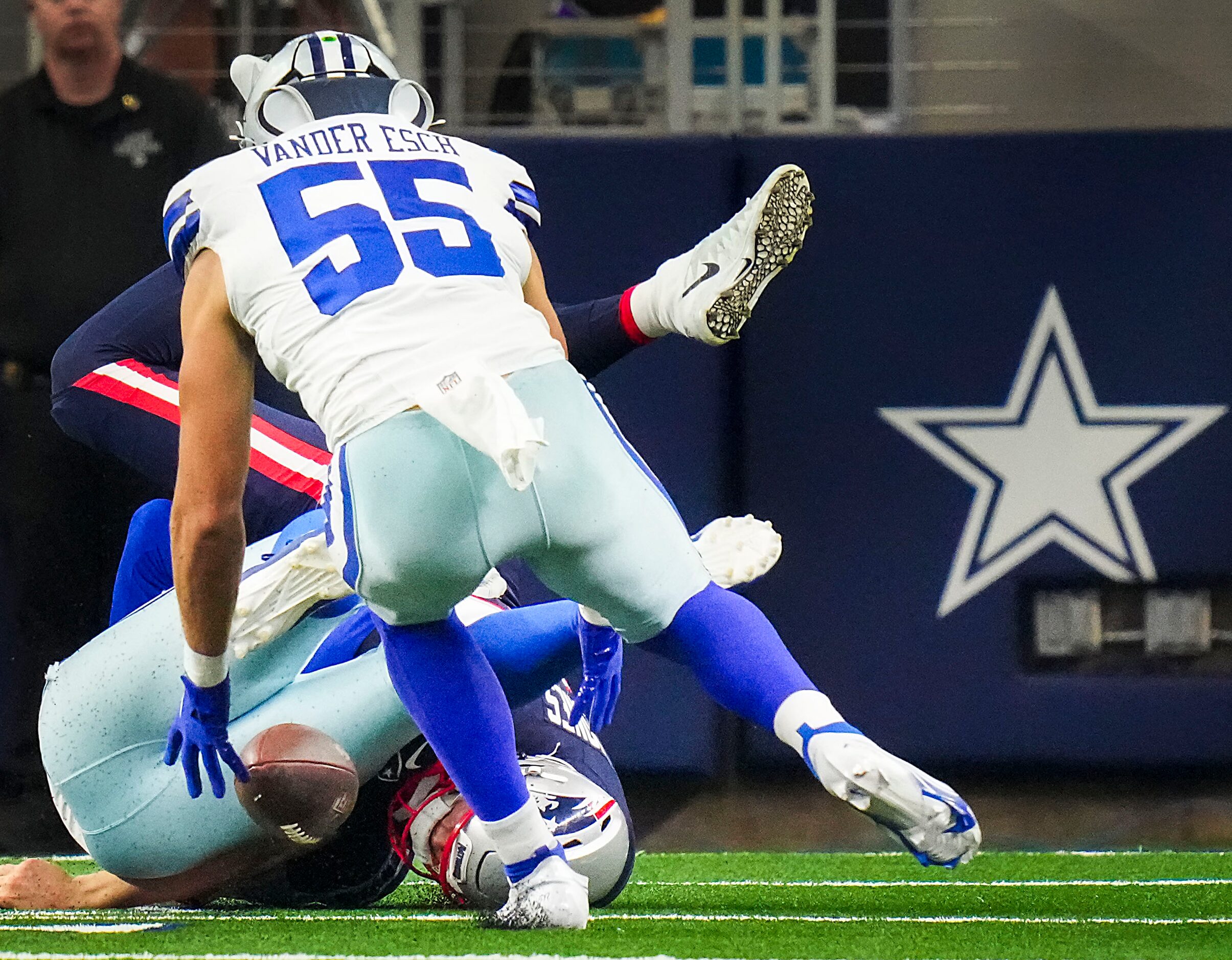 New England Patriots quarterback Mac Jones (10) fumbles as he is hit by Dallas Cowboys...