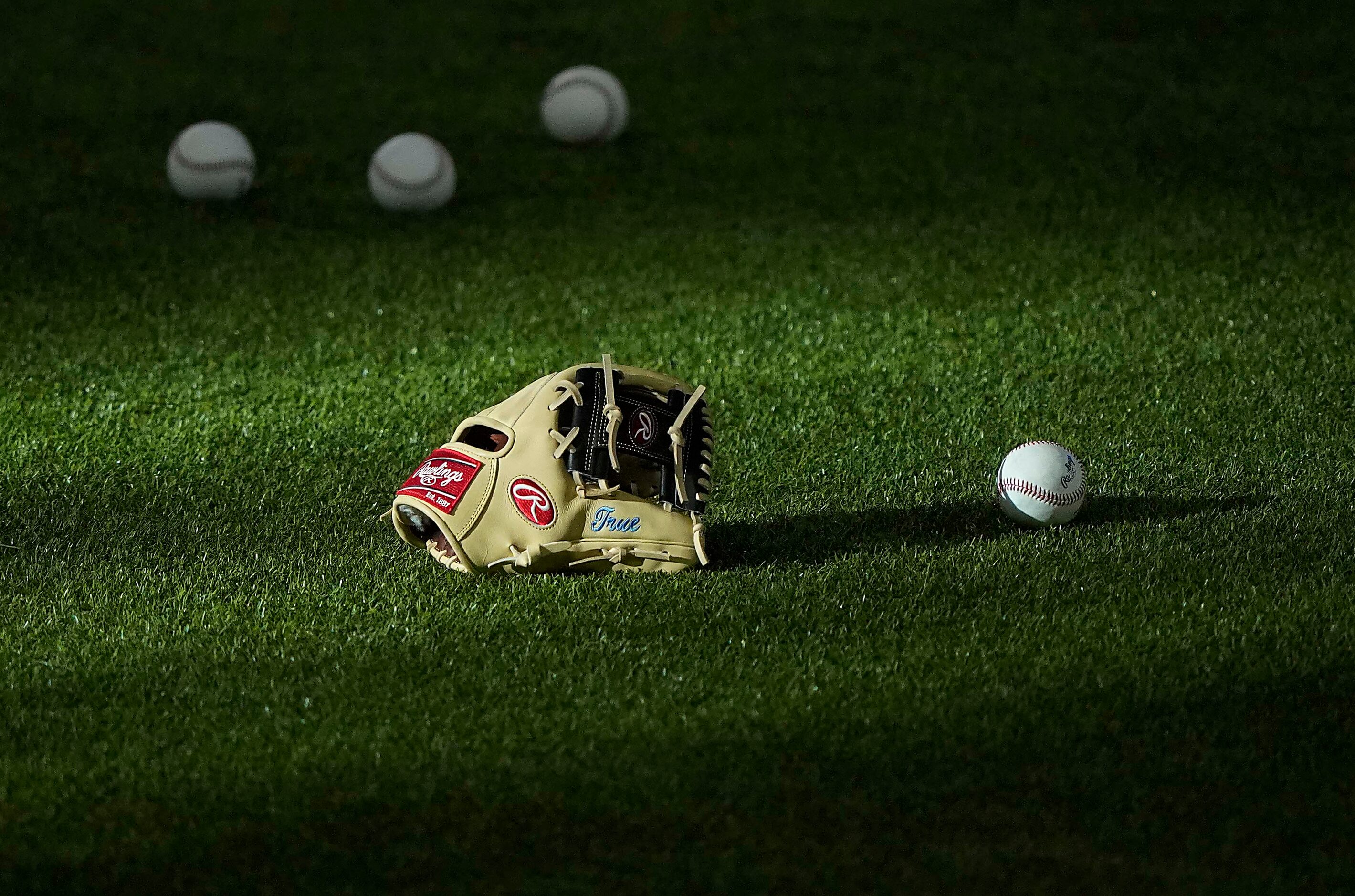 Colorado Rockies shortstop Trevor Story's mitt rests in a patch of sunlight before an...