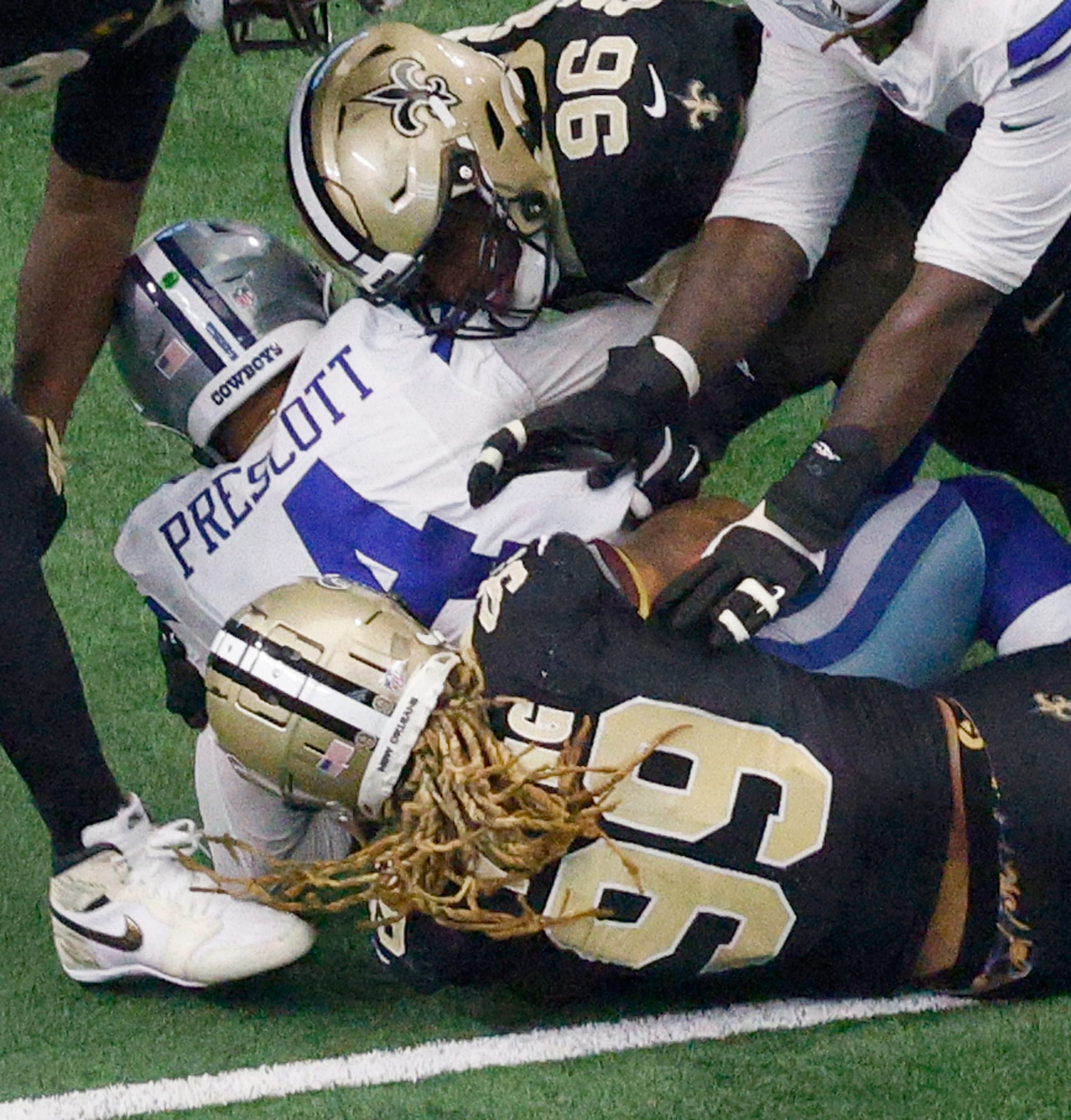 Dallas Cowboys quarterback Dak Prescott (4) is sacked by New Orleans Saints defensive end...