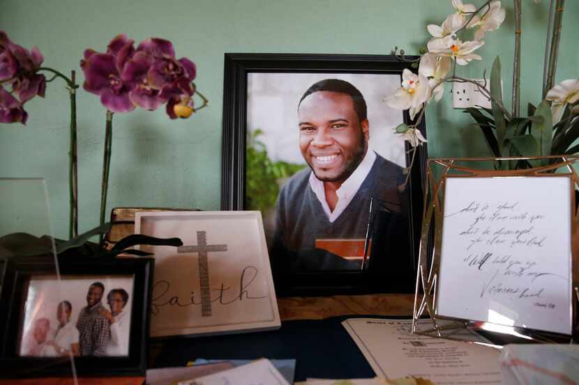 A photo of Botham Jean with photos and cards was displayed on one of the tables at his...
