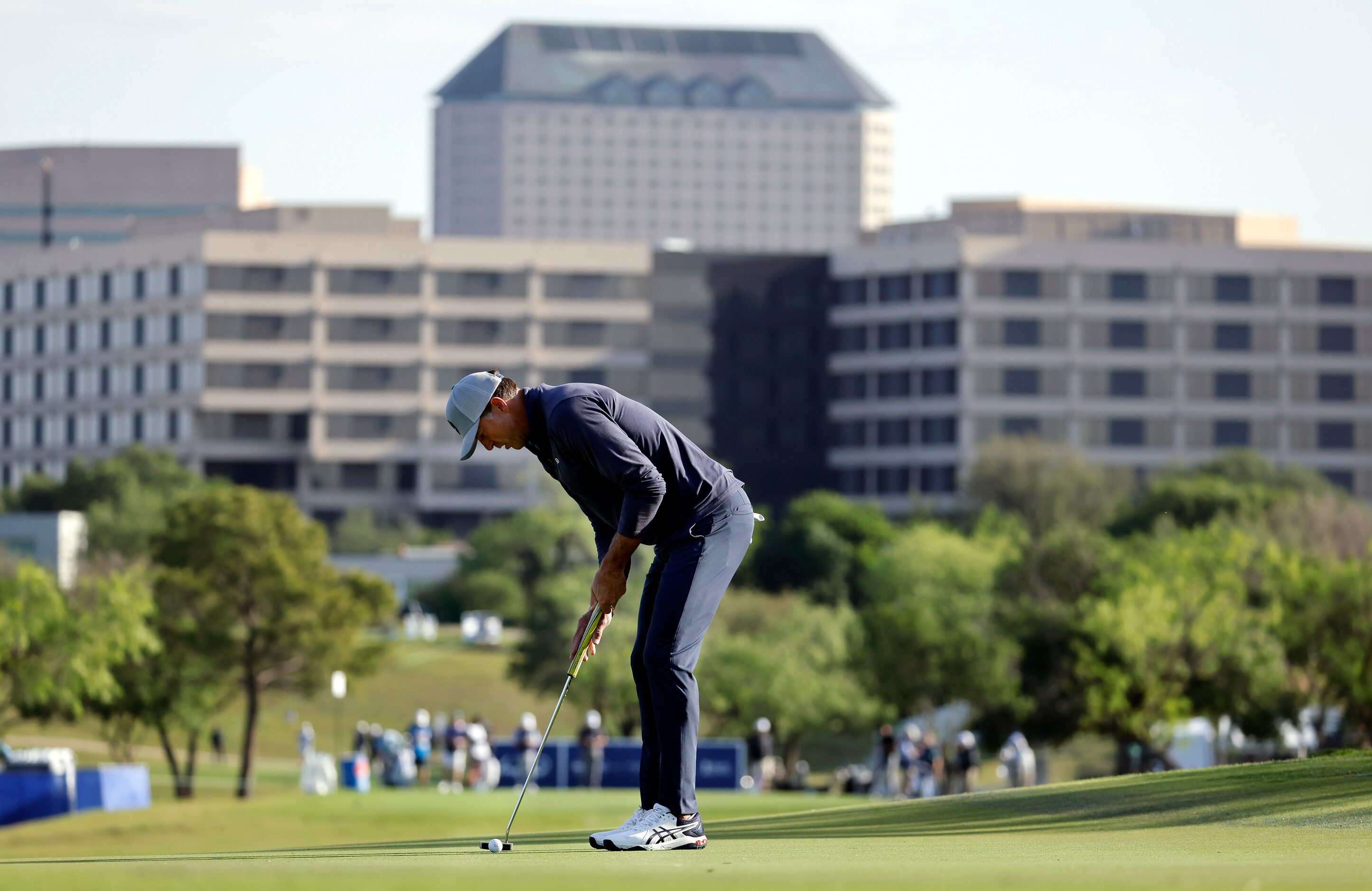 Former Dallas Stars player Mike Modano stands over his putt on the 11th green in the Invited...