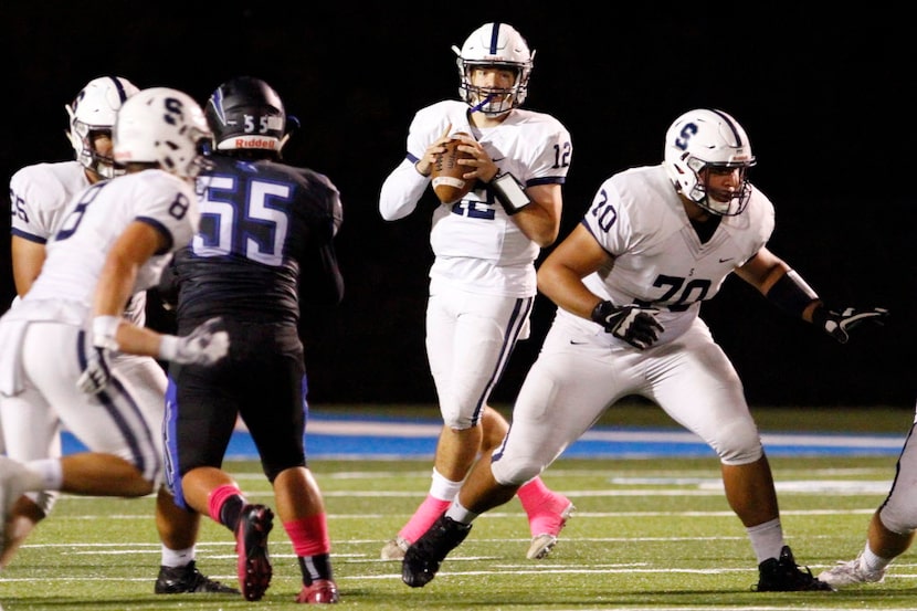 Fort Worth All Saints senior quarterback Shaun Taylor (12) looks for his receivers while...