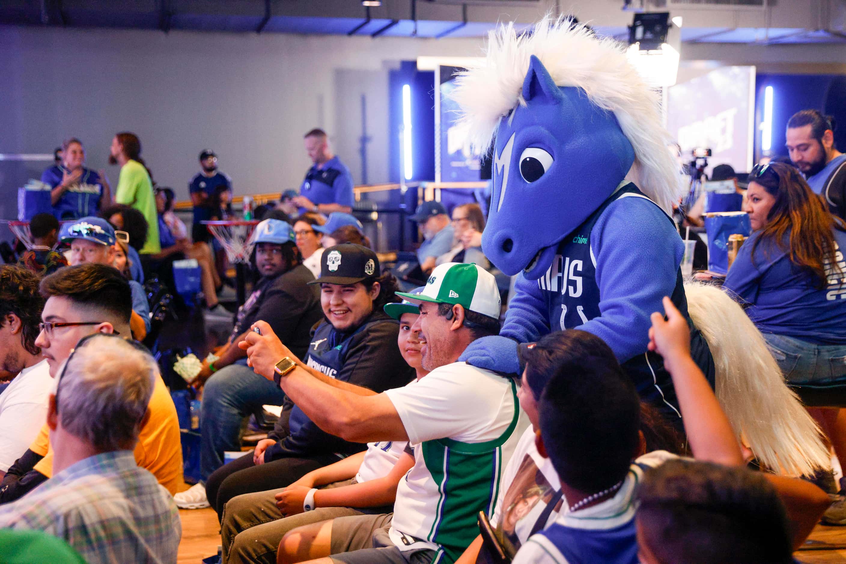 Dallas Mavericks mascot Champ interacts with fans during a 2023 NBA Draft watch party at The...