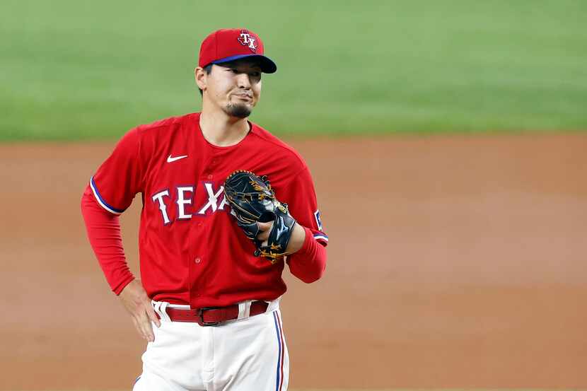Texas Rangers starting pitcher Kohei Arihara reacts after giving up a second home run to the...