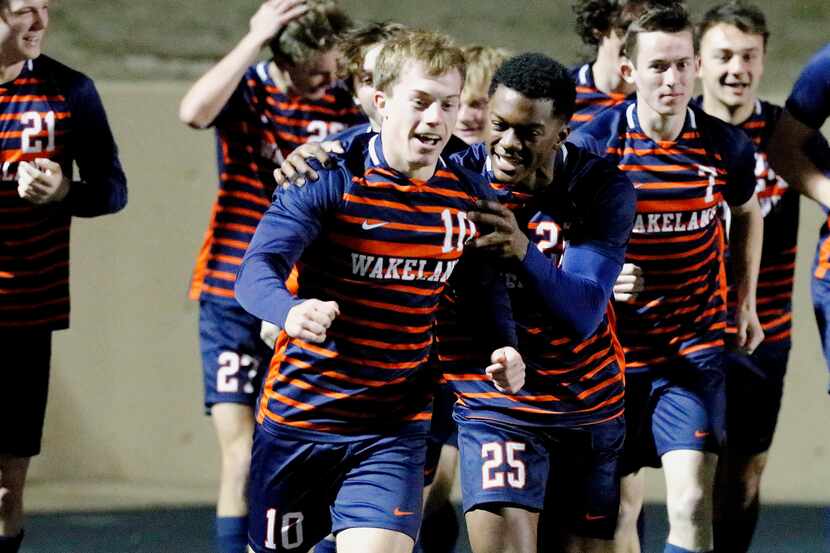 Wakeland midfielder Nathan Bowman (10) is congratulated by defender Kyle Davis (25) and the...