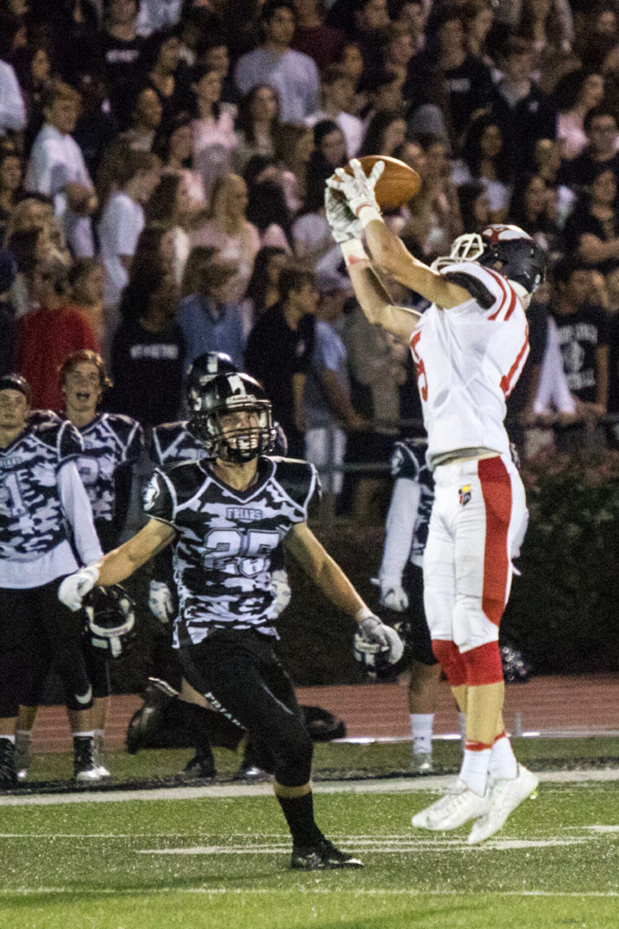 John Paul wide receiver Luke Hyslop (15) catches a pass during Bishop Lynch's matchup...