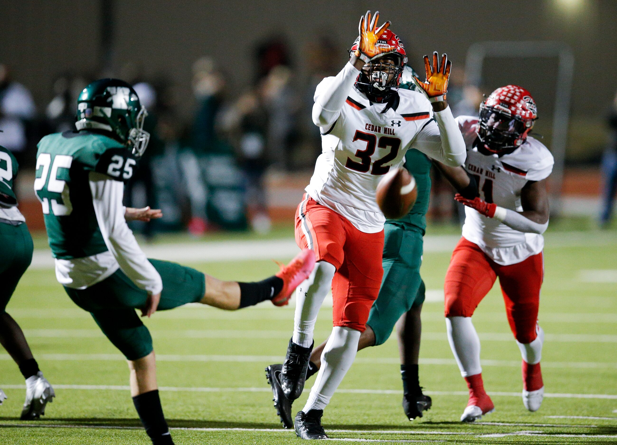 Cedar Hill senior defensive end Charles Esters III attempts to block a punt by Waxahachie...