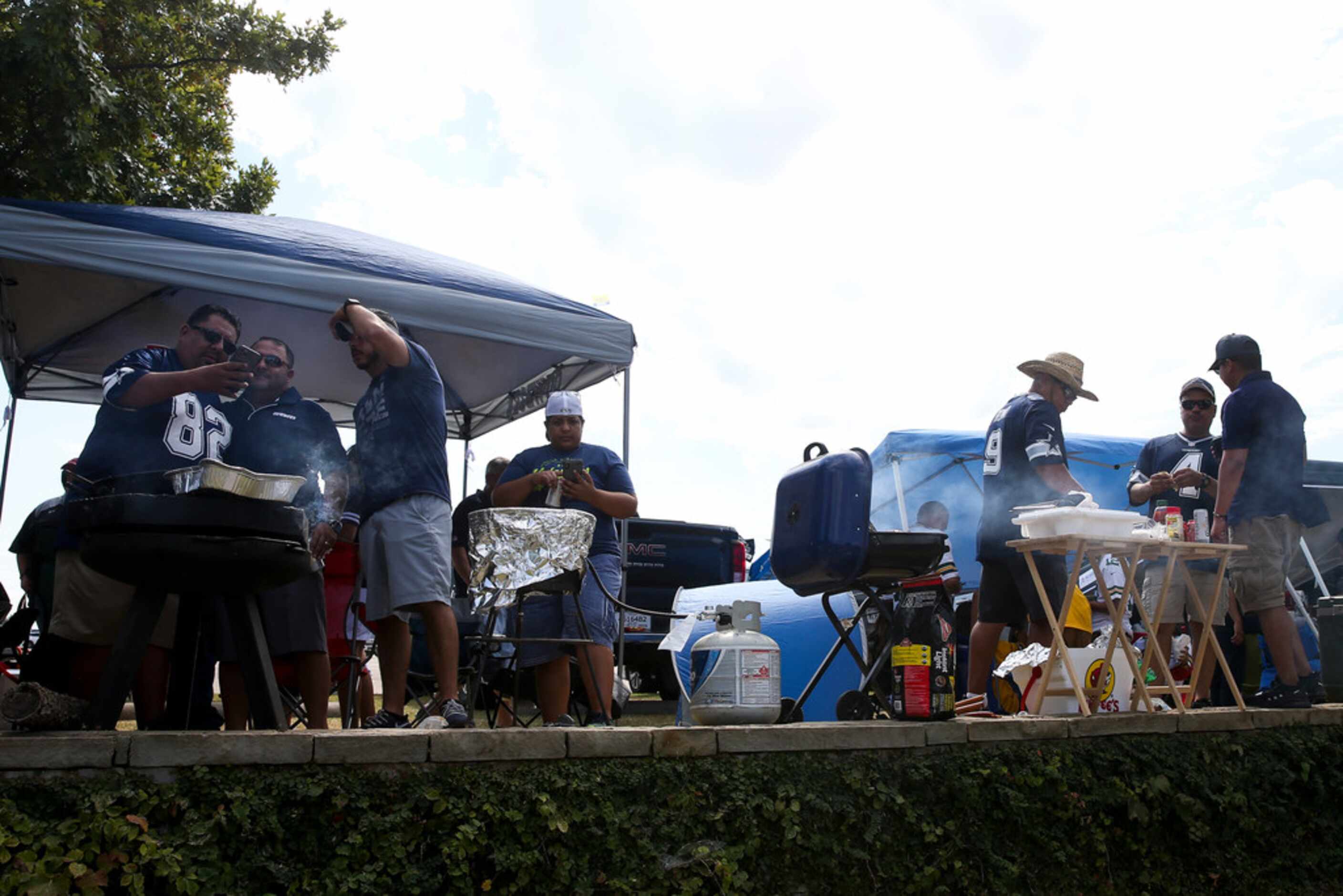 Fans tailgate before an NFL game between the Dallas Cowboys and Green Bay Packers on Sunday,...
