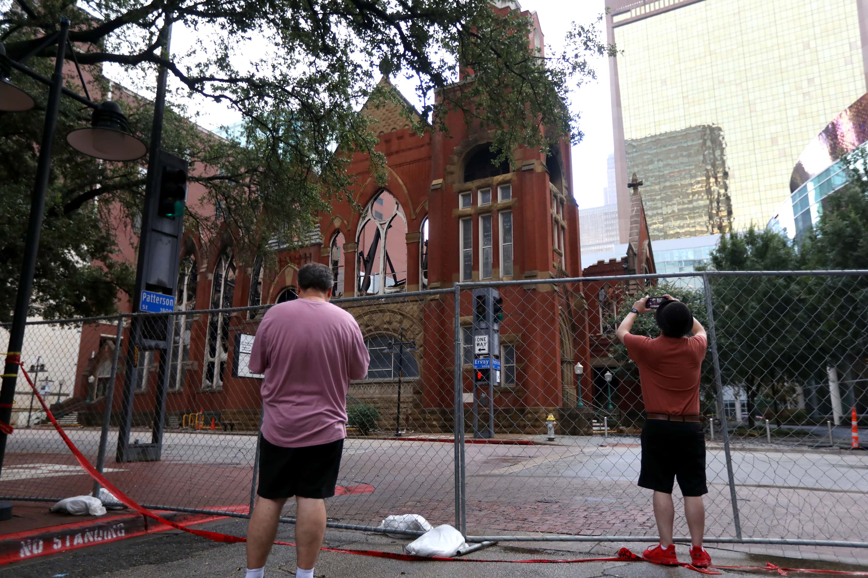 People gather at 1717 San Jacinto St., the site of a fire at First Baptist Dallas church,...