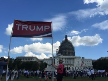  Jim McDonald, right, holds a pro-Donald Trump sign at an anti-Iran deal rally featuring the...