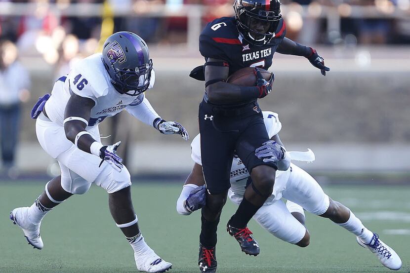 Texas Tech's Devin Lauderdale (6) tries to get past Central Arkansas' Bobby Watkins (7) and...