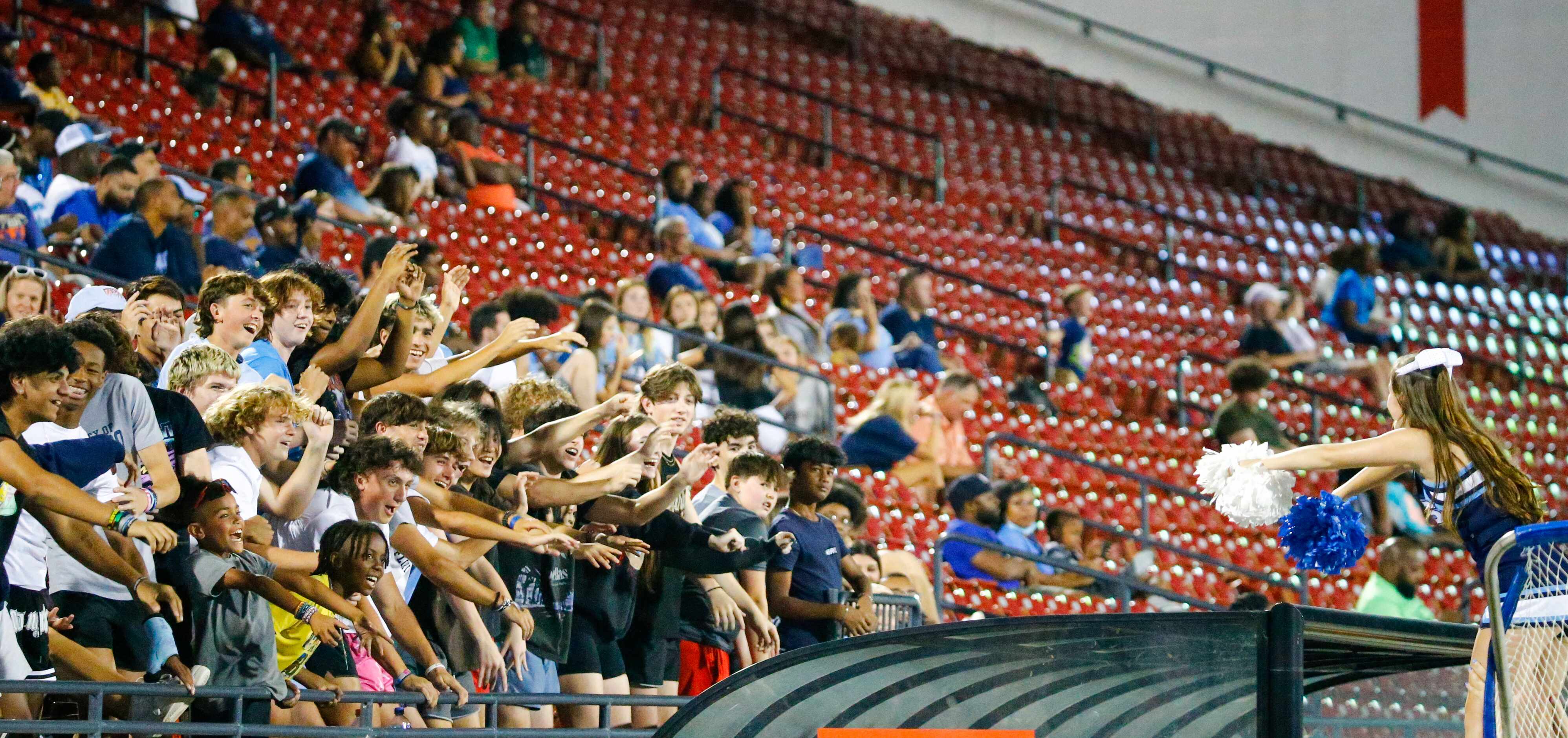 Emerson High School students and fans react to a game of rollercoaster led by an EHS...