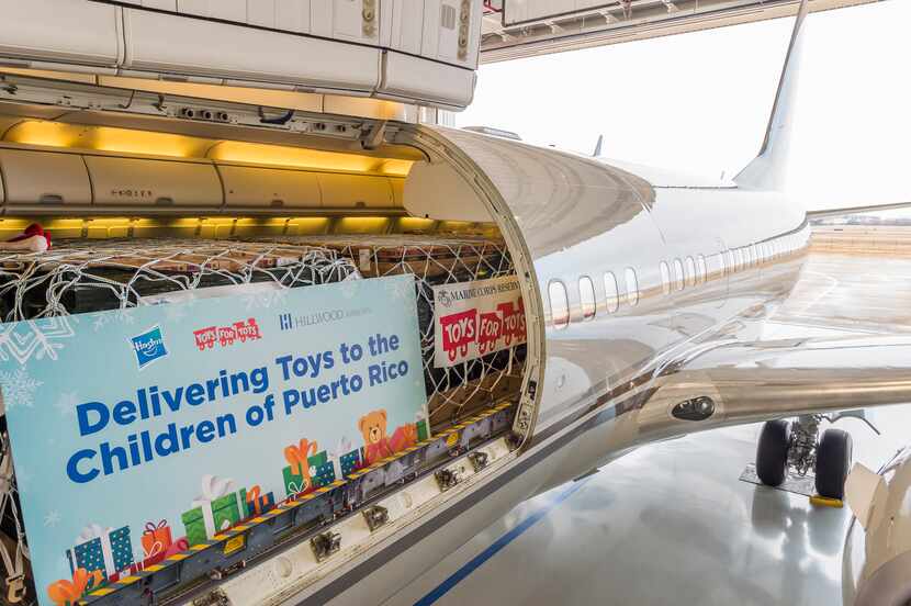Toys loaded onto a Hillwood Airways plane that will deliver 30,000 Hasbro toys and Games to...