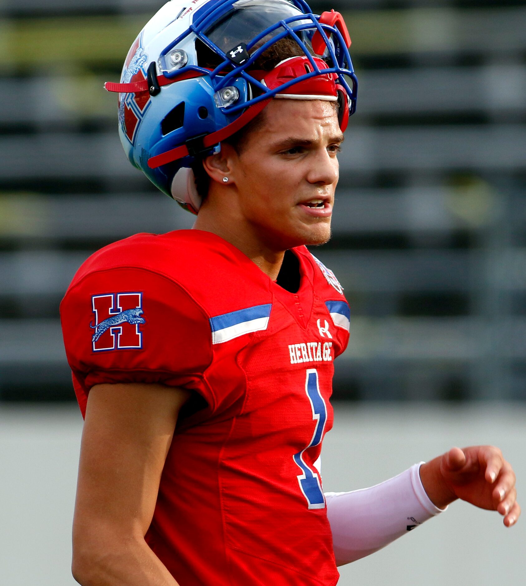 Midlothian Heritage quarterback Daelin Rader (1) takes a brief break during team warm-ups...