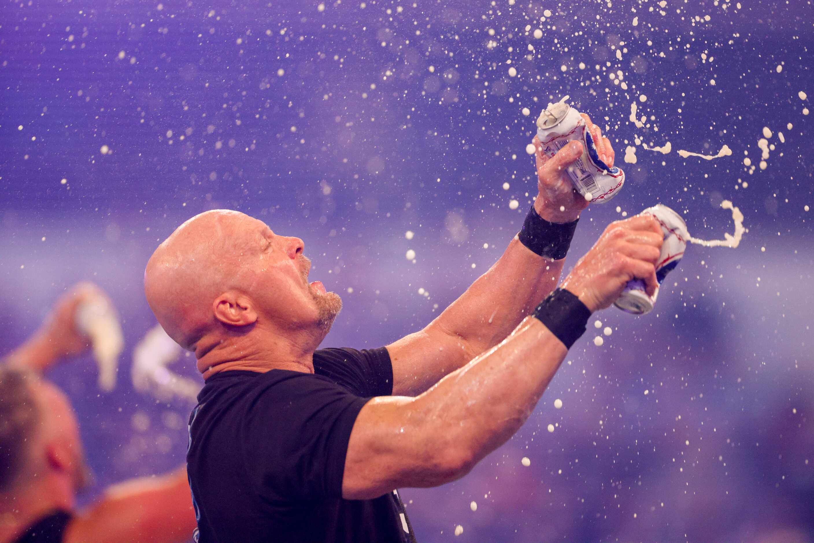 “Stone Cold” Steve Austin chugs beer after a match at WrestleMania Sunday at AT&T Stadium in...