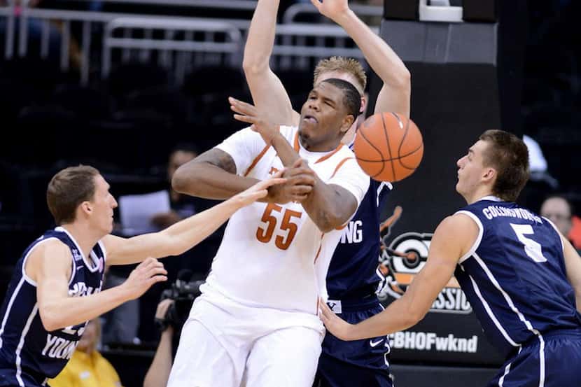 BYU Cougars' Skyler Halford, left, strips the ball from Texas Longhorns' Cameron Ridley (55)...