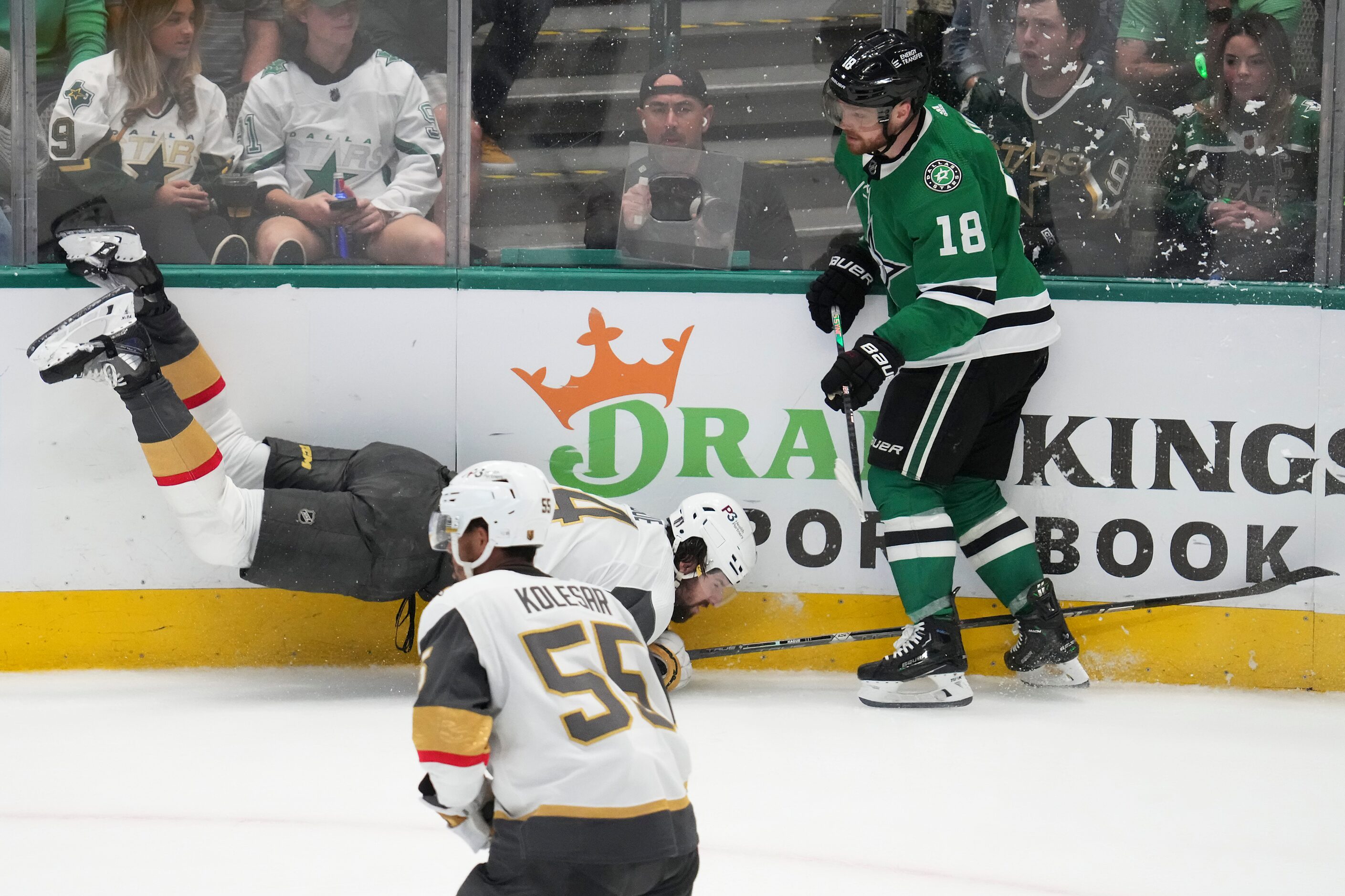 Vegas Golden Knights defenseman Nicolas Hague (14) is upended by Dallas Stars center Max...