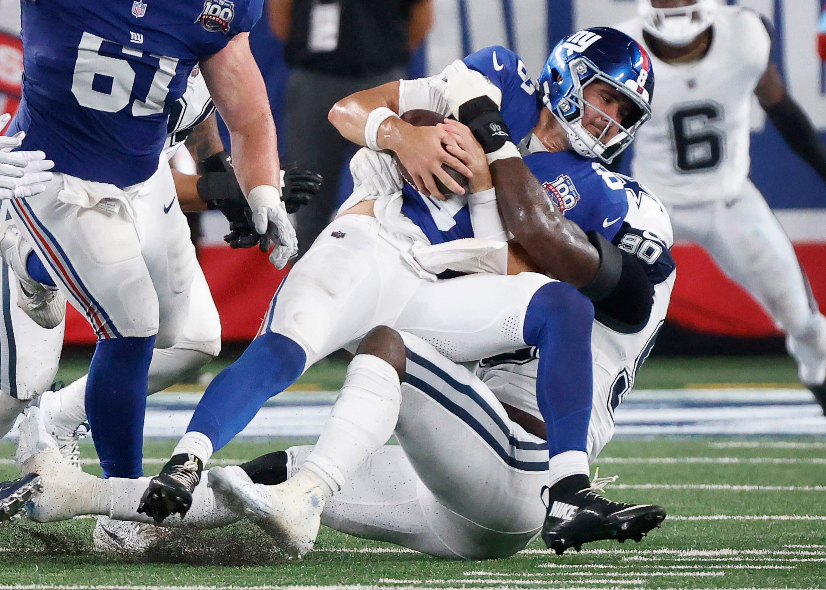 Dallas Cowboys defensive end DeMarcus Lawrence (90) brings down New York Giants quarterback...