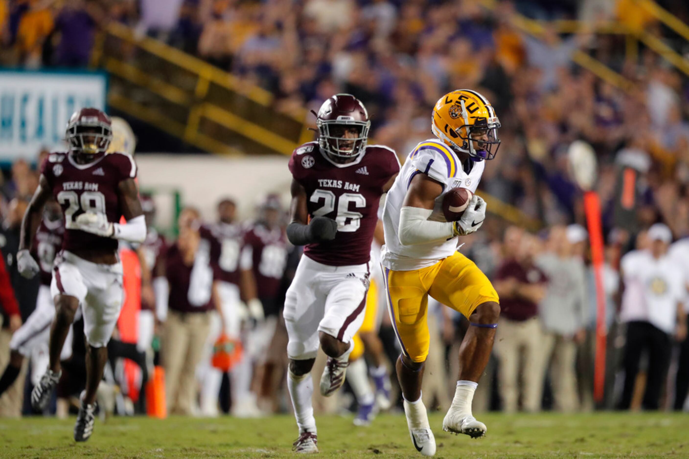 LSU wide receiver Ja'Marr Chase (1) pulls in a touchdown reception ahead of Texas A&M...