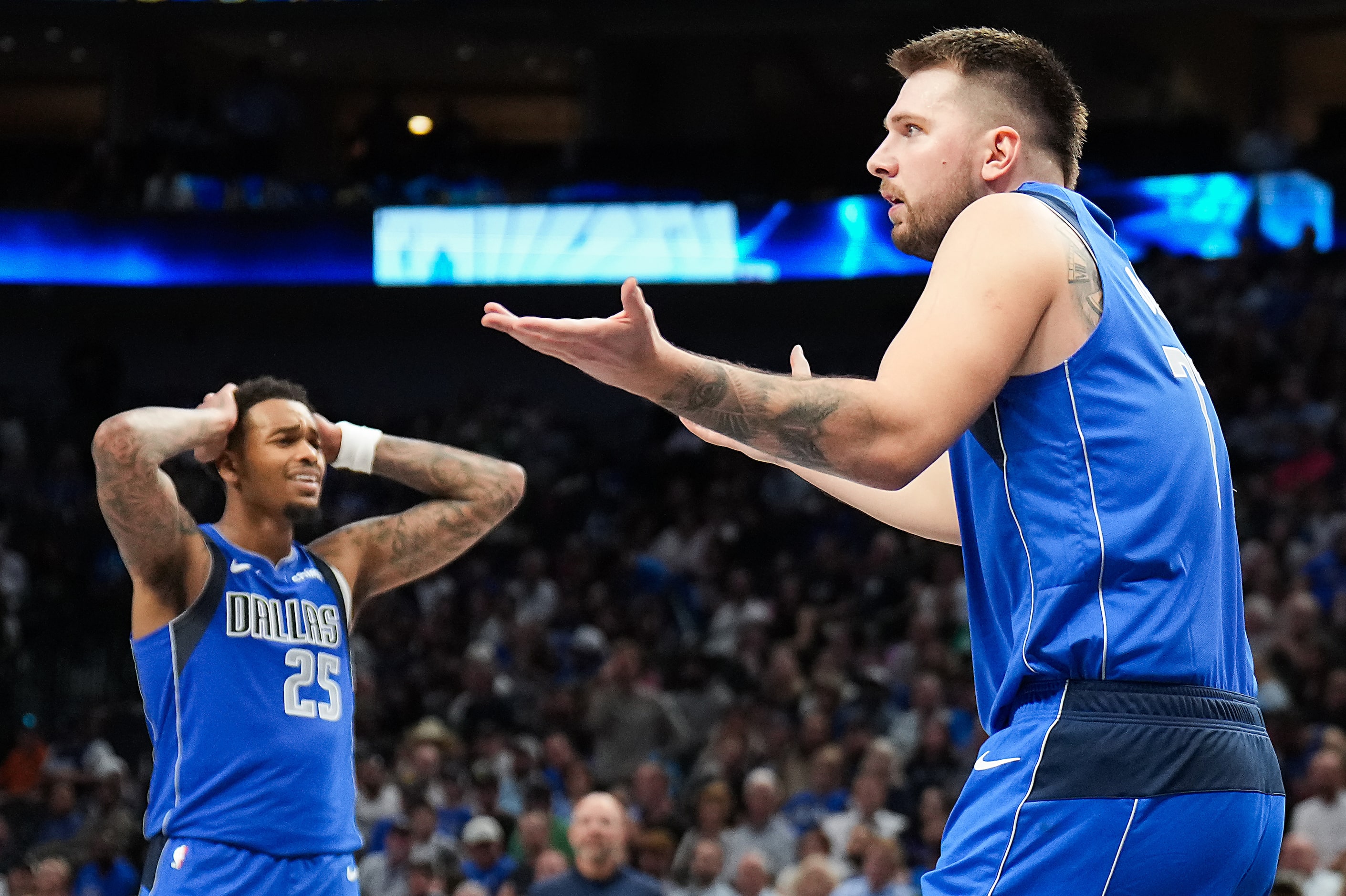 Dallas Mavericks guard Luka Doncic and forward P.J. Washington (25) react after Doncic was...