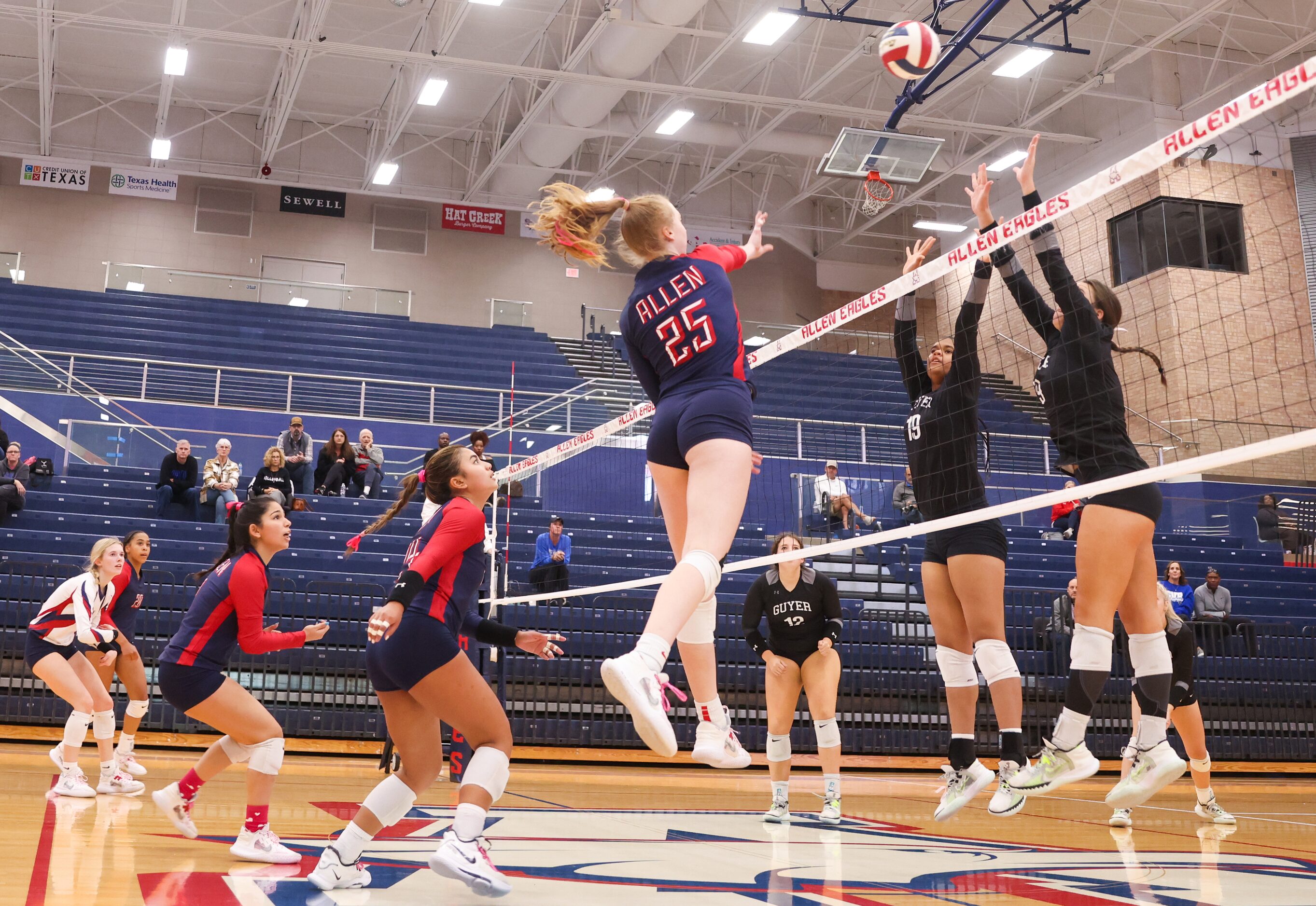 Allen sophomore Katelyn Bowman (25) spikes the ball past Denton Guyer sophomore Sydney...