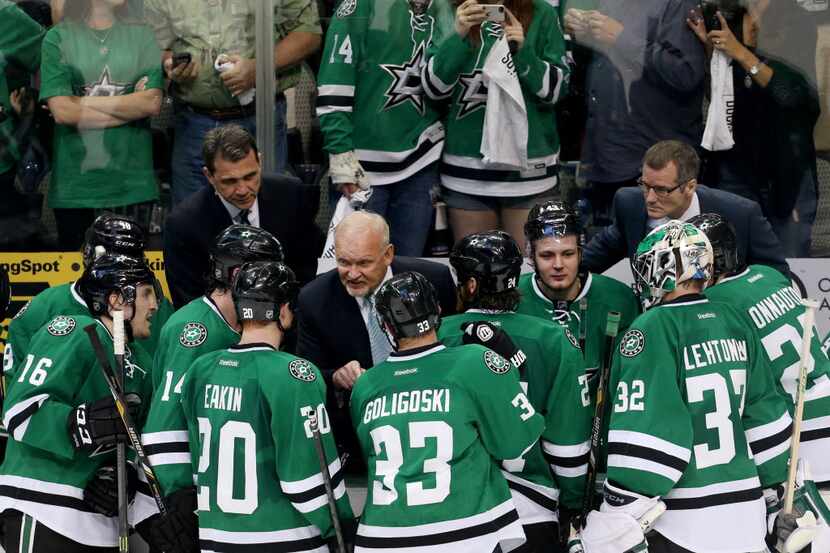 Dallas Stars head coach Lindy Ruff talks with his team during a timeout in the third period...