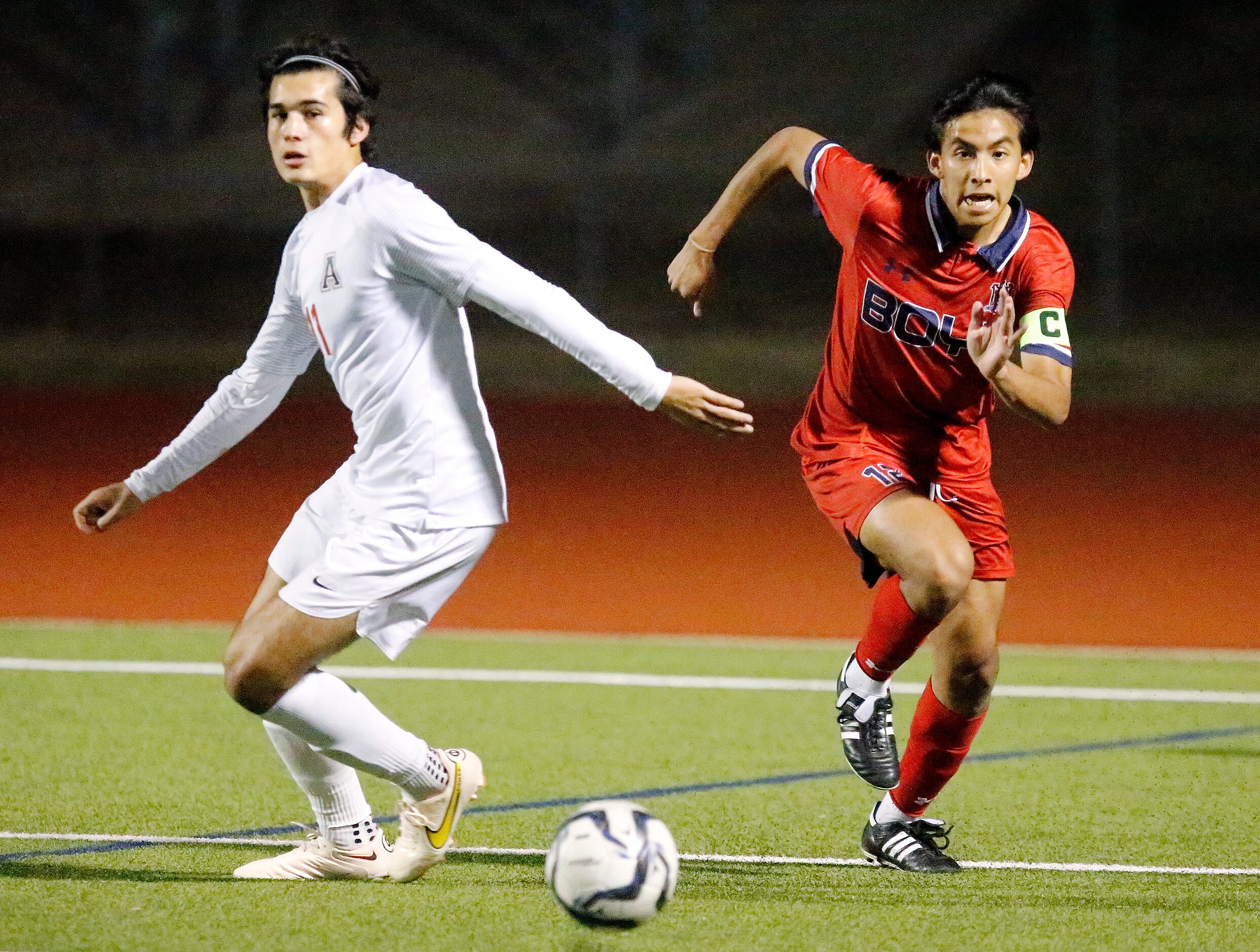 Allen High School defender Sebastian Sastoque (11) and McKinney Boyd High School midfielder...