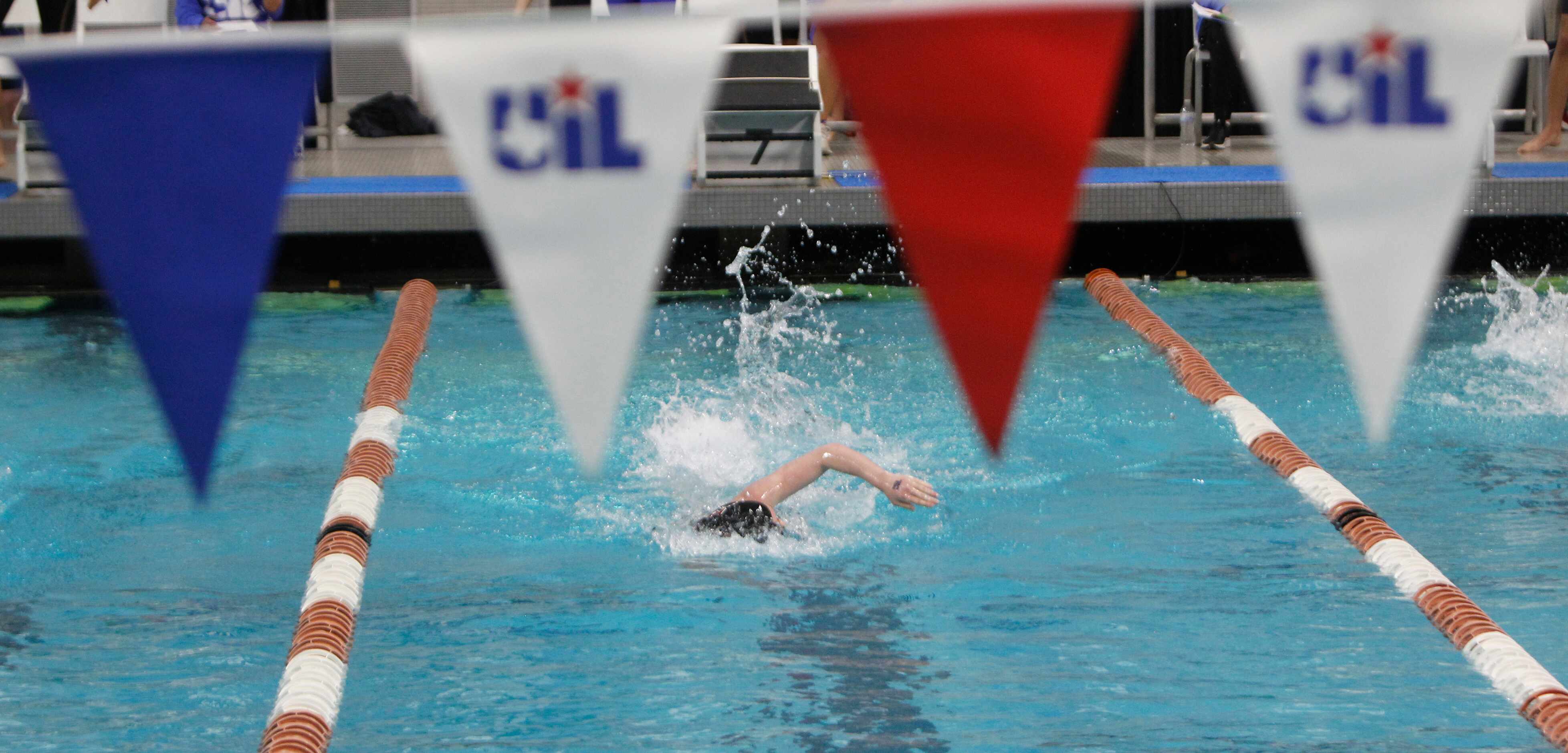 A swimmer competes during 5A competition. The first day of the UIL state swimming and diving...
