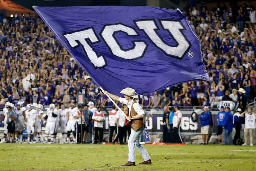The TCU flag is waved on the field after a first half touchdown against the Kansas Jayhawks...