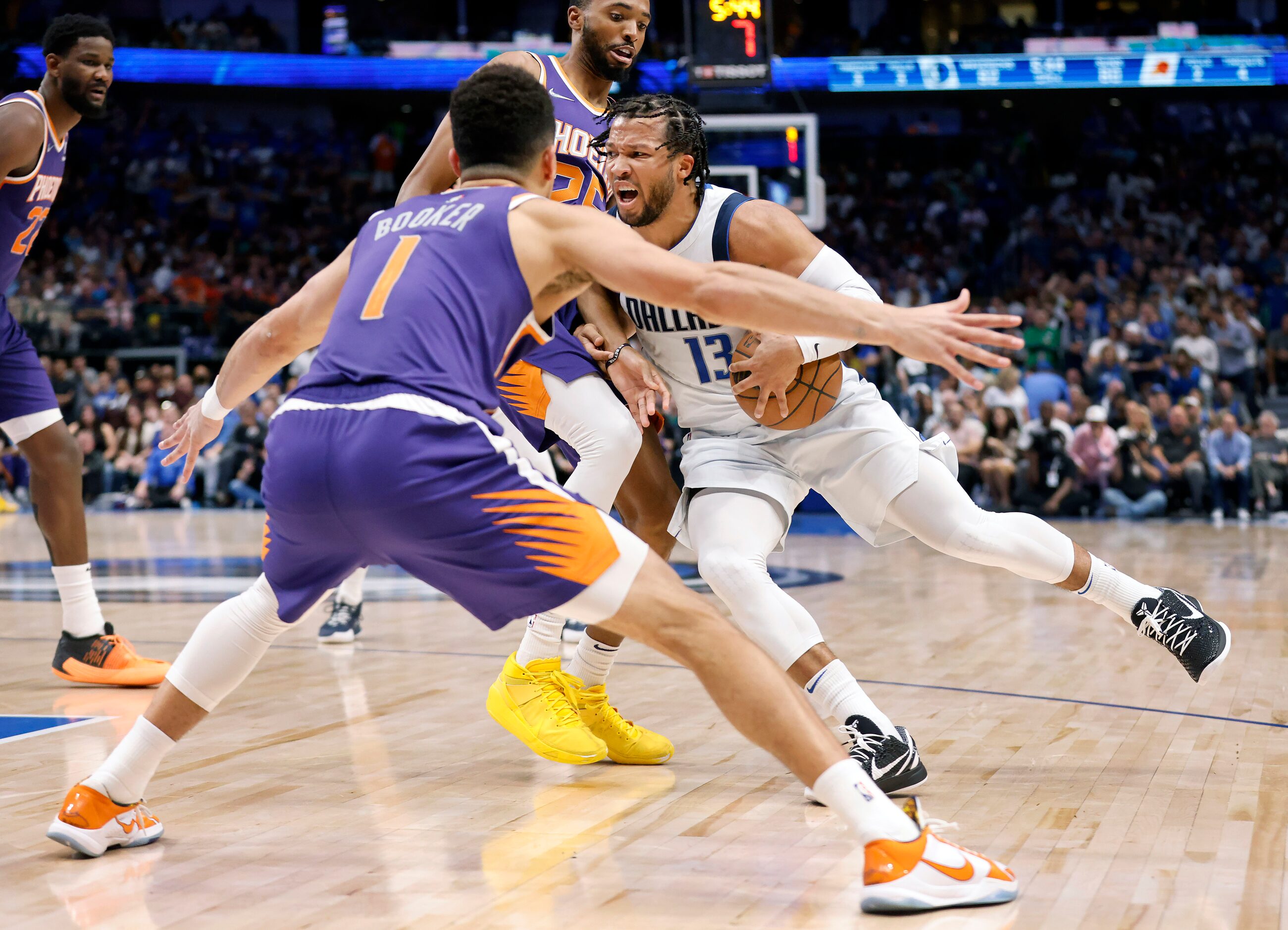 Dallas Mavericks guard Jalen Brunson (13) attempts to drive the lane between Phoenix Suns...