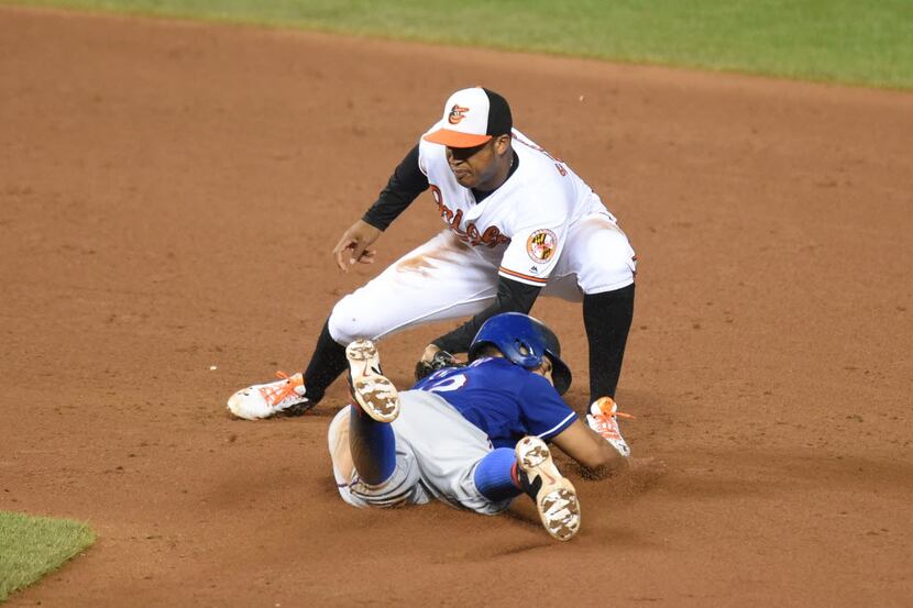 BALTIMORE, MD - AUGUST 03:  Jonathan Schoop #6 of the Baltimore Orioles tags out Rougned...