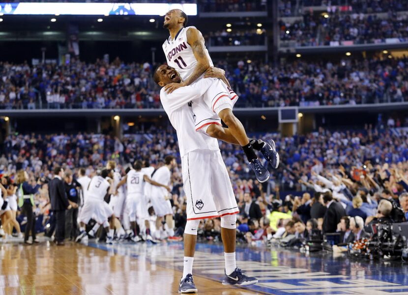 Connecticut Huskies guard Ryan Boatright (11) is hoisted in to the air by a teammate...