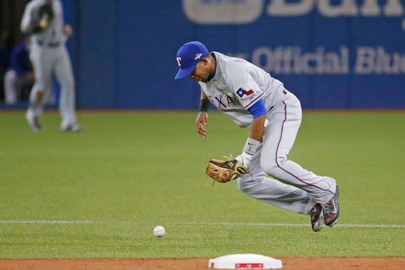Texas Rangers shortstop Elvis Andrus (1) commits an error while bobbling a grounder hit by...