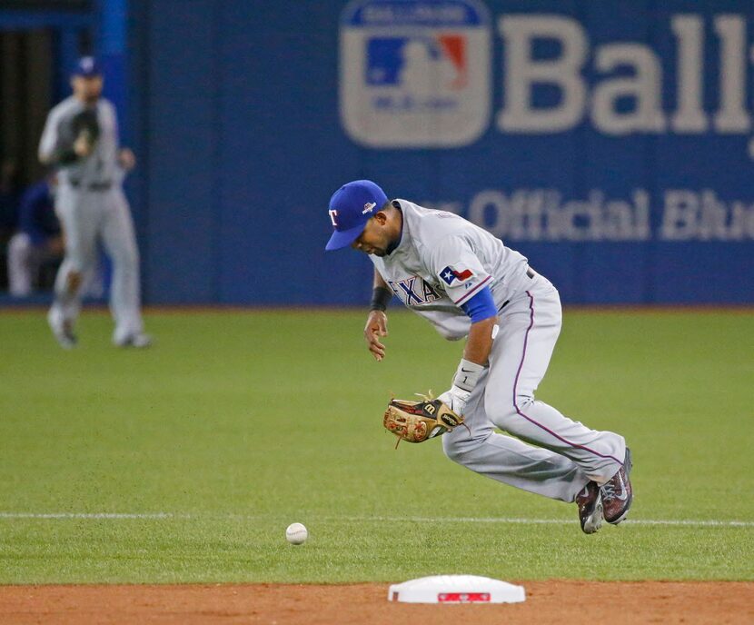 Texas Rangers shortstop Elvis Andrus (1) commits an error while bobbling a grounder hit by...