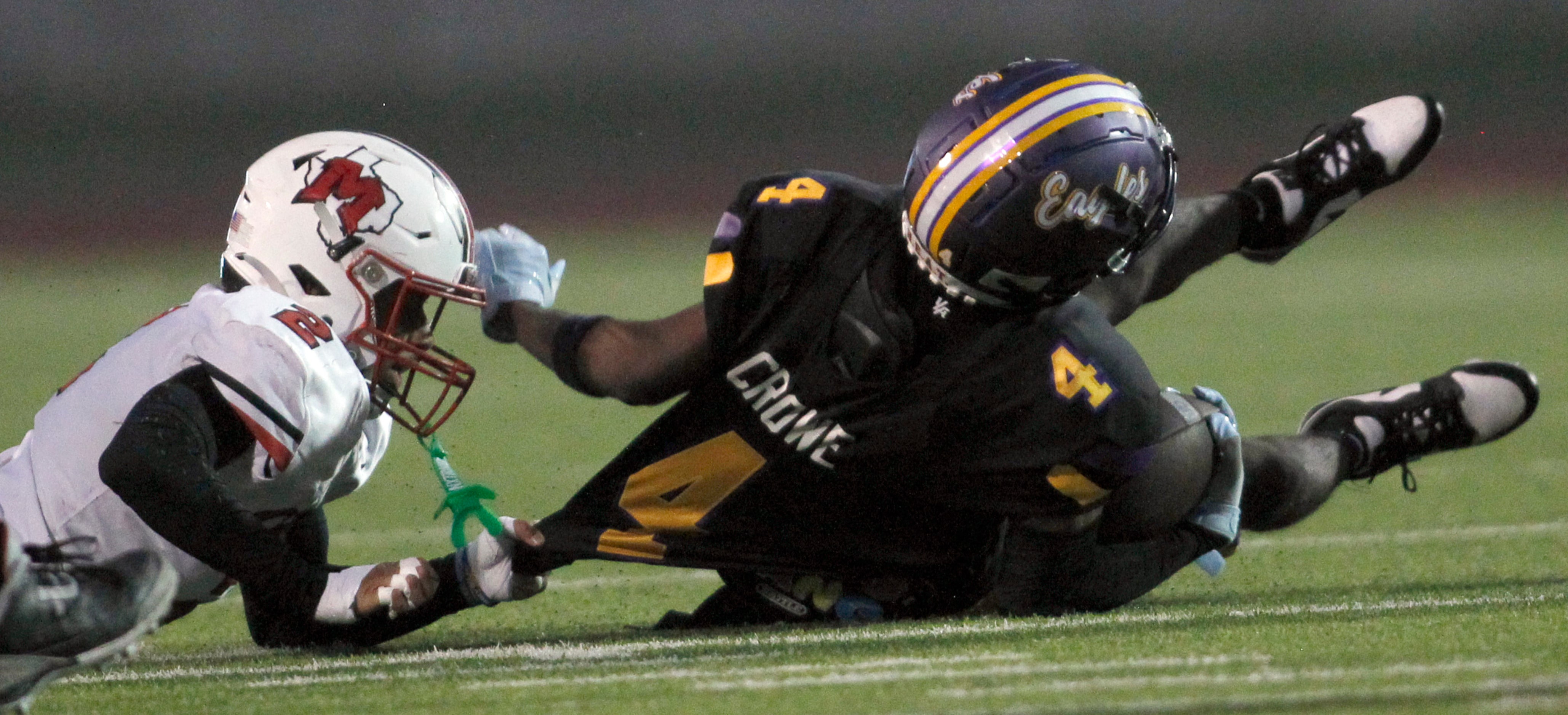 Richardson receiver Dameon Crowe (4), right, is pulled down by his jersey at the hand of...