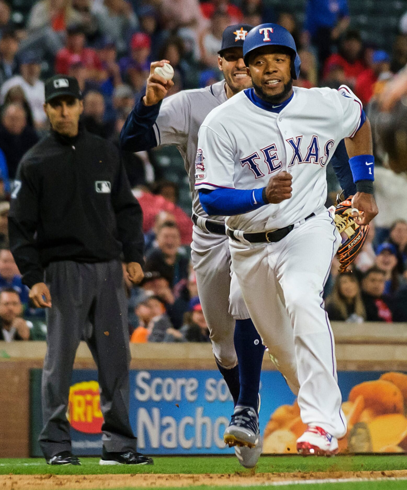 Texas Rangers shortstop Elvis Andrus is caught in a rundown trying to score on a groundout...