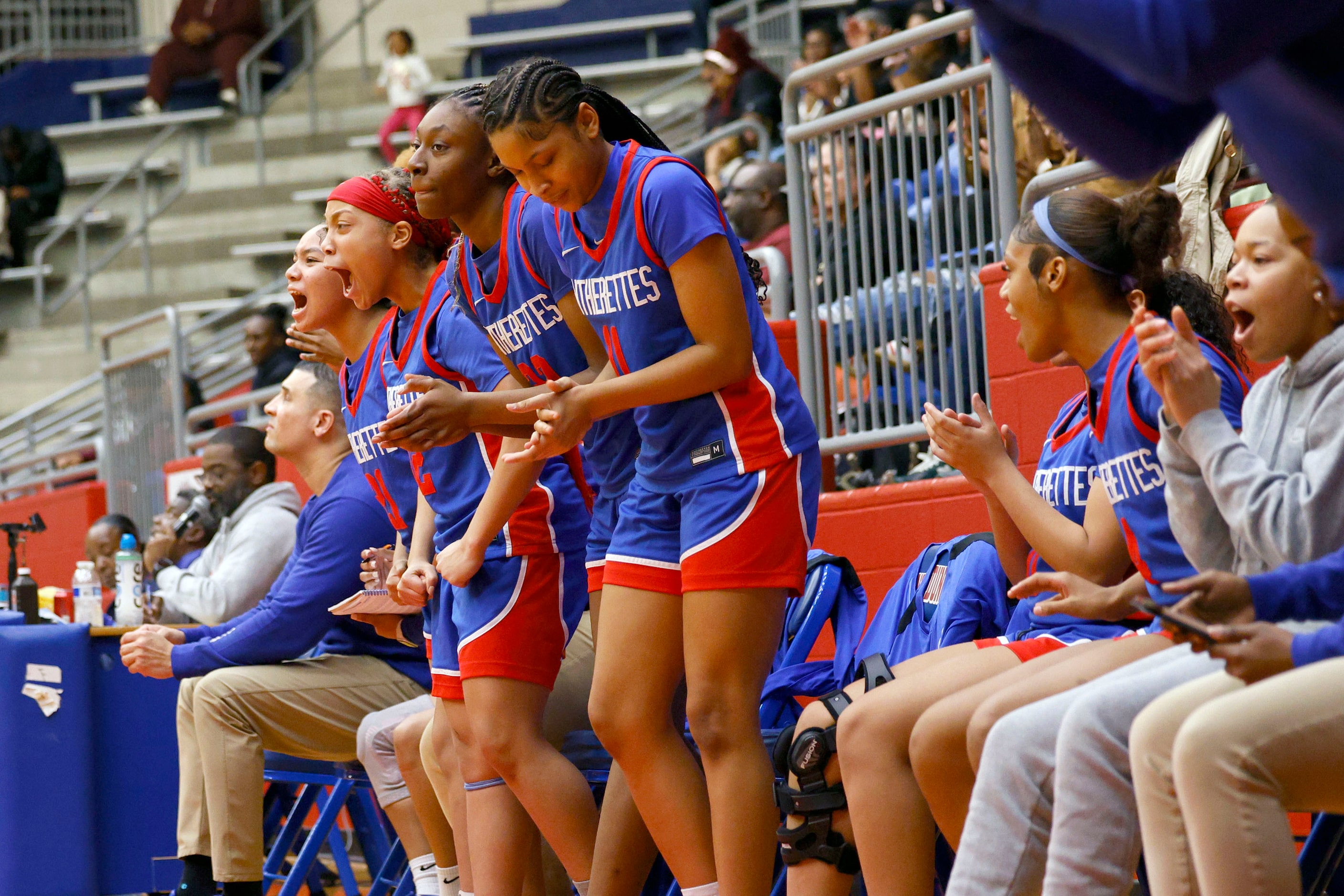 Duncanville players cheer during the second half of a high school basketball game in Sandra...