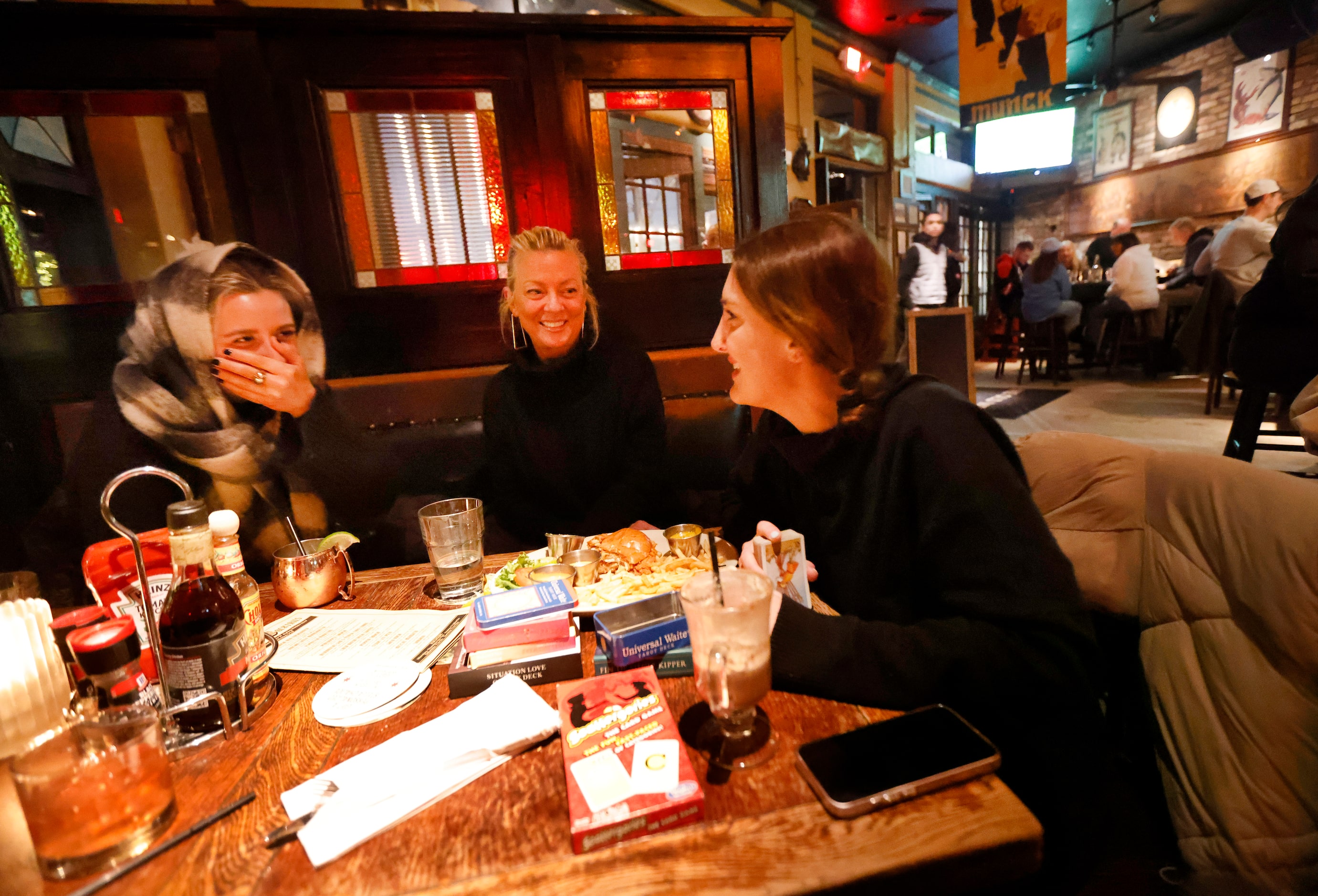 On a cold rainy winter night, bar patrons Zoë Goodwin (left) and Jordan Goodwin (right)...