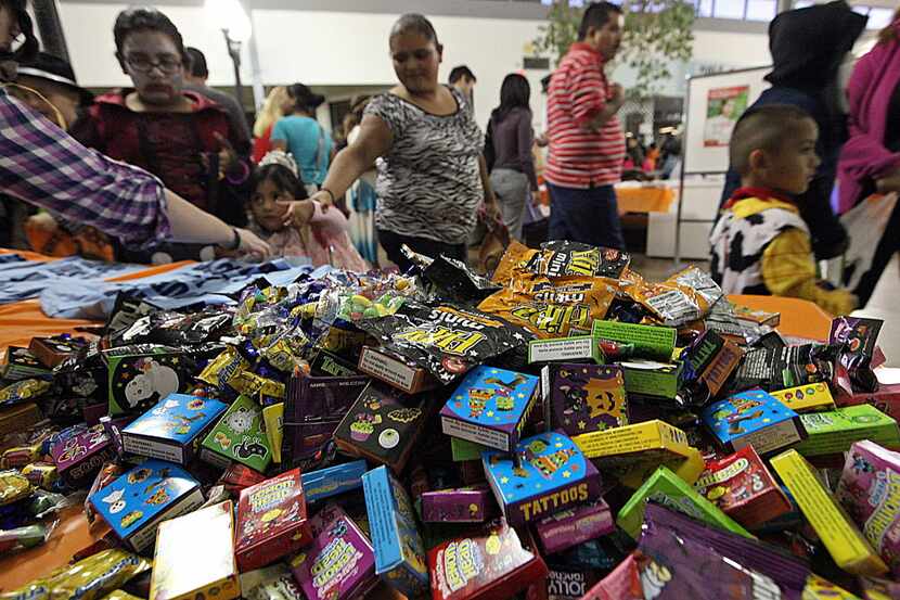 Piles of candy were handed out to trick-or=treaters at the Plano Police Department's Kids...