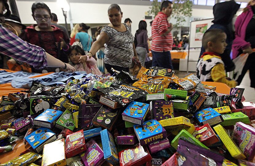 Piles of candy were handed out to trick-or=treaters at the Plano Police Department's Kids...