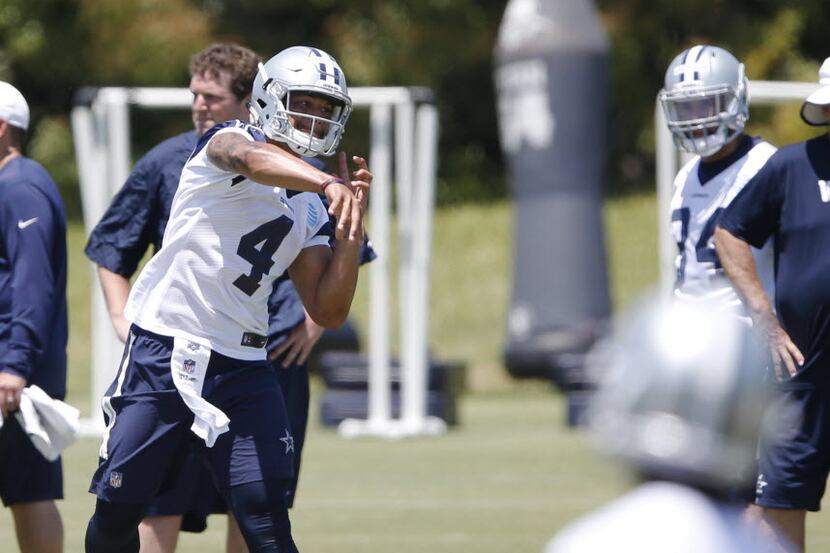 Dallas Cowboys quarterback Dak Prescott (4) throws on a play during rookie minicamp at the...