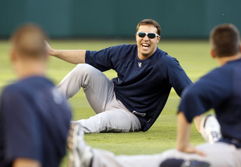 New York Yankees infielder Mark Teixeira laughs while stretching during  practice for their...