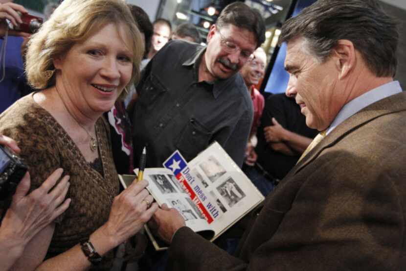 Becky Roe of Coal Valley, Iowa, showed Gov. Rick Perry a picture of himself as a high school...