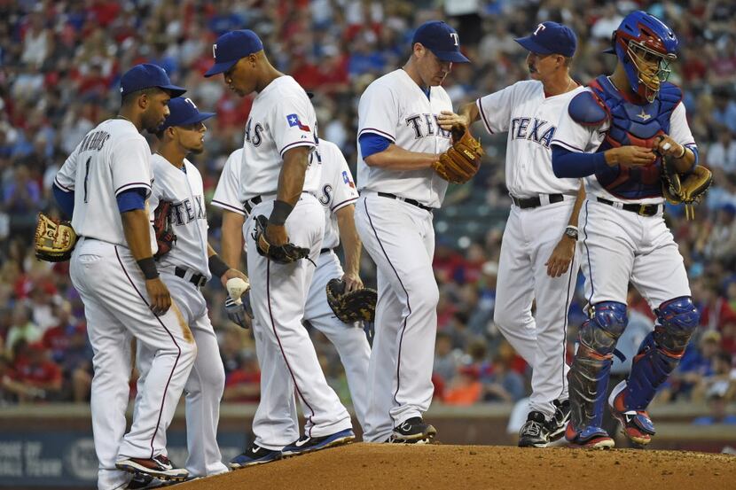 Texas Rangers pitching coach Mike Maddux (31) talks to Texas Rangers starting pitcher Colby...