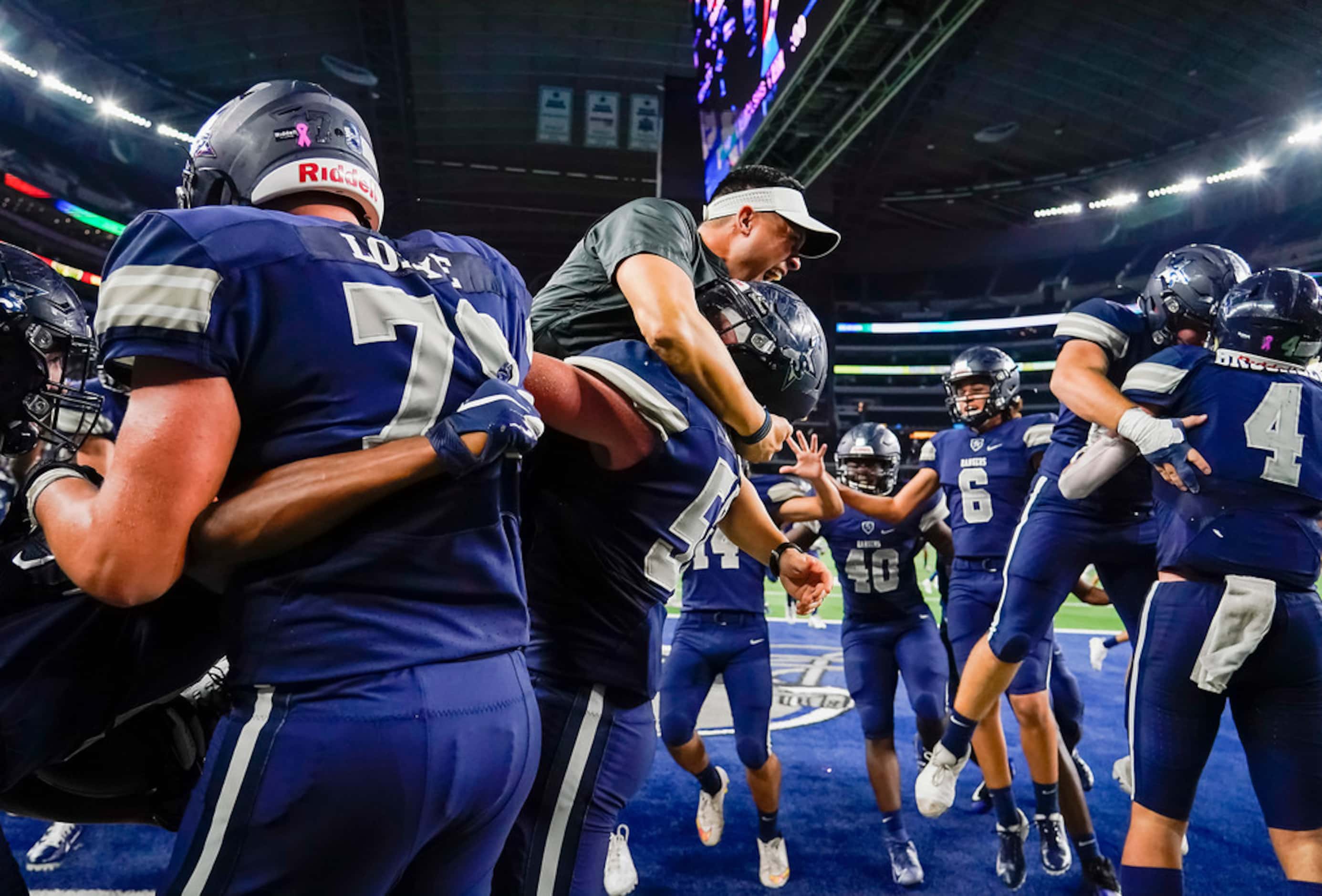 Frisco Lone Star Head coach Jeff Rayburn joins the celebration in the end zone after running...