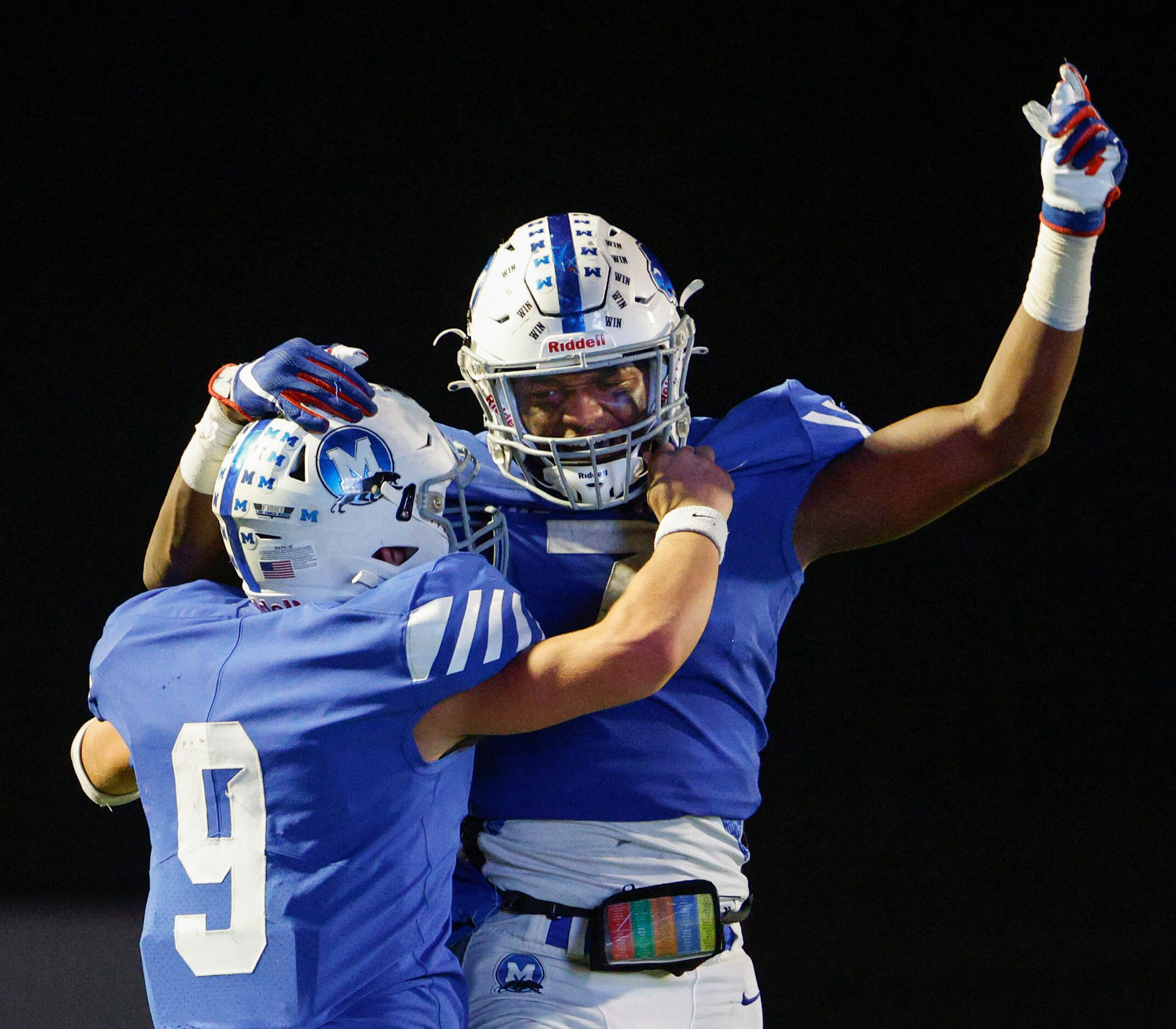 Midlothian quarterback Chad Ragle (9) celebrates his touchdown with running back De’ago...