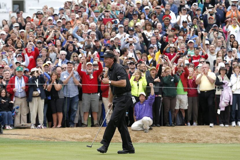 Phil Mickelson smiles after his par putt on18th green during the final round of the Waste...