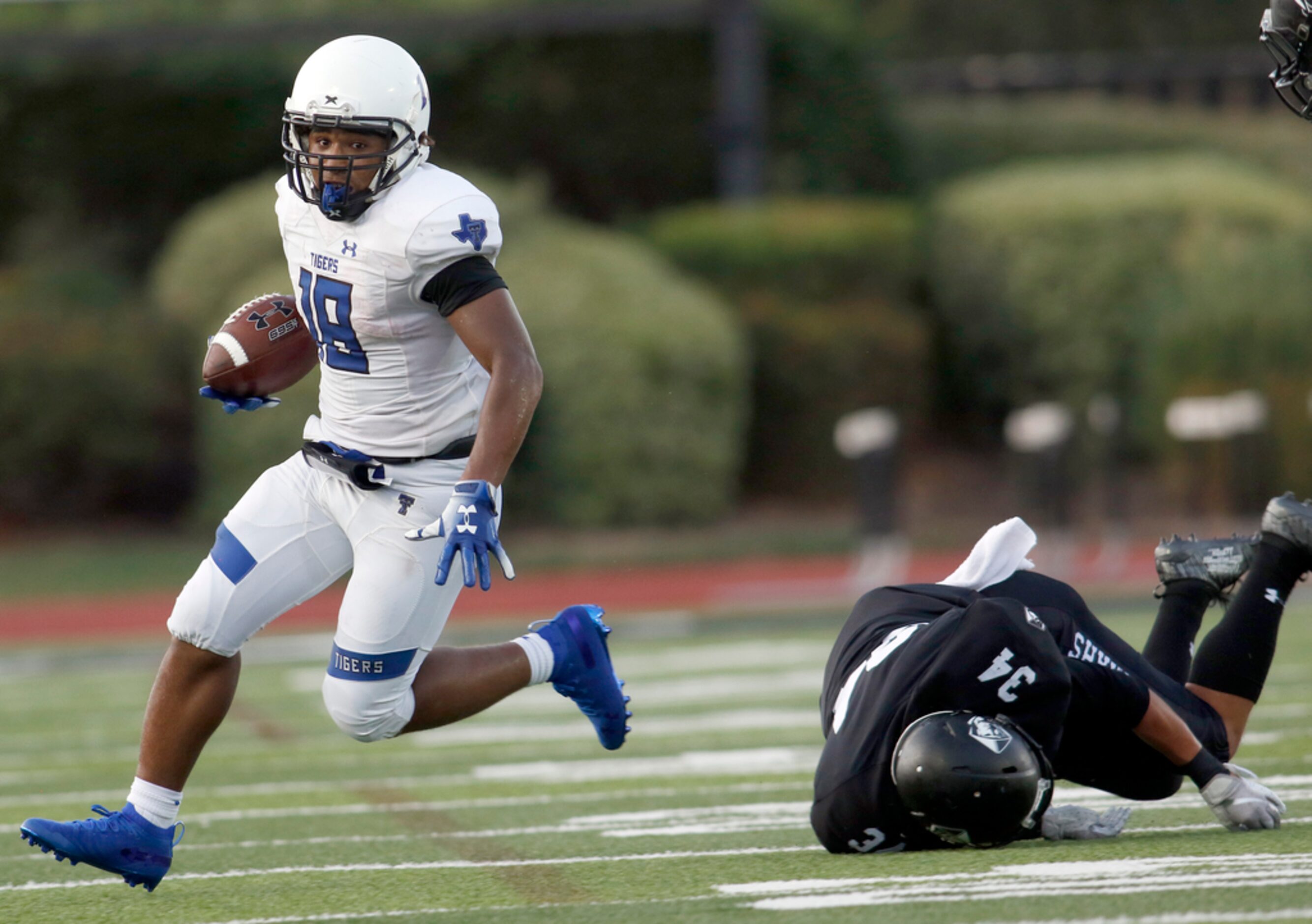 Trinity Christian-Cedar Hill running back Emari Matthews (18) runs away from the pursuit of...