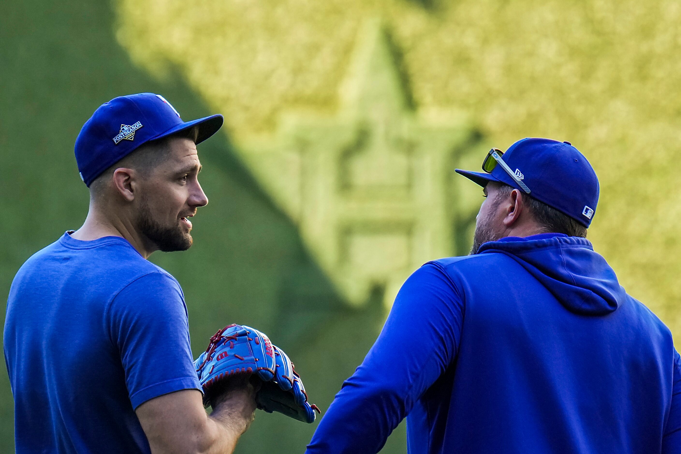 Texas Rangers starting pitcher Nathan Eovaldi (left) talks with catching coach Bobby Wilson...