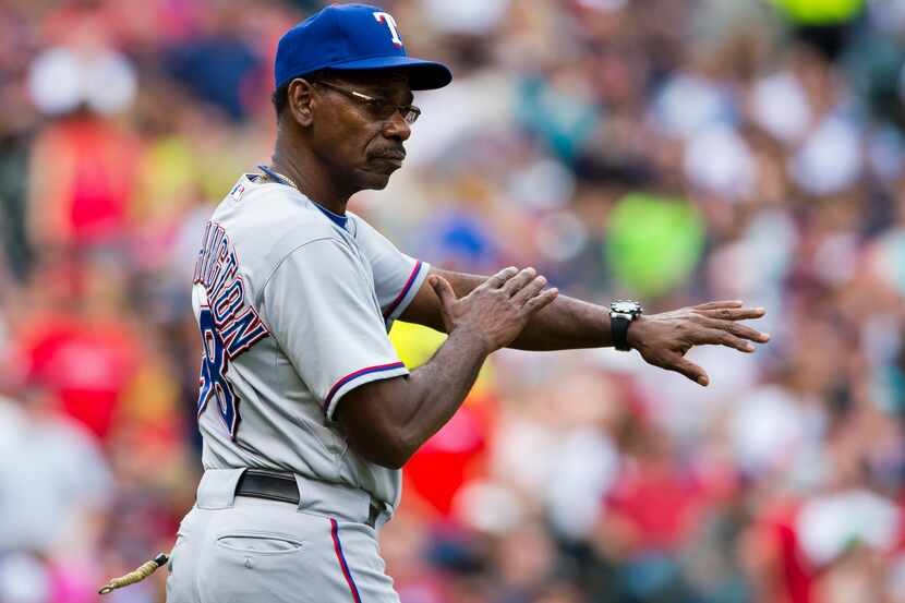 CLEVELAND, OH - JULY 28: Manager Ron Washington #38 of the Texas Rangers signals to the...